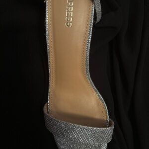 Shiny silver dress sandals with heels. Very pretty. Dress up or wear with jeans.